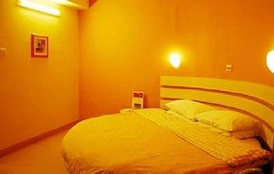 Starmoon Inn (Changchun Guangchang) in Changchun, image may contain: Lighting, Furniture, Bed, Indoors