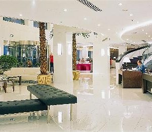 Xijiao Hotel Beijing in Beijing, image may contain: Foyer, Indoors, Person, Furniture
