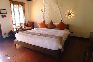 Le Vimarn Cottages & Spa in Ko Samet, image may contain: Furniture, Bed, Bedroom, Resort