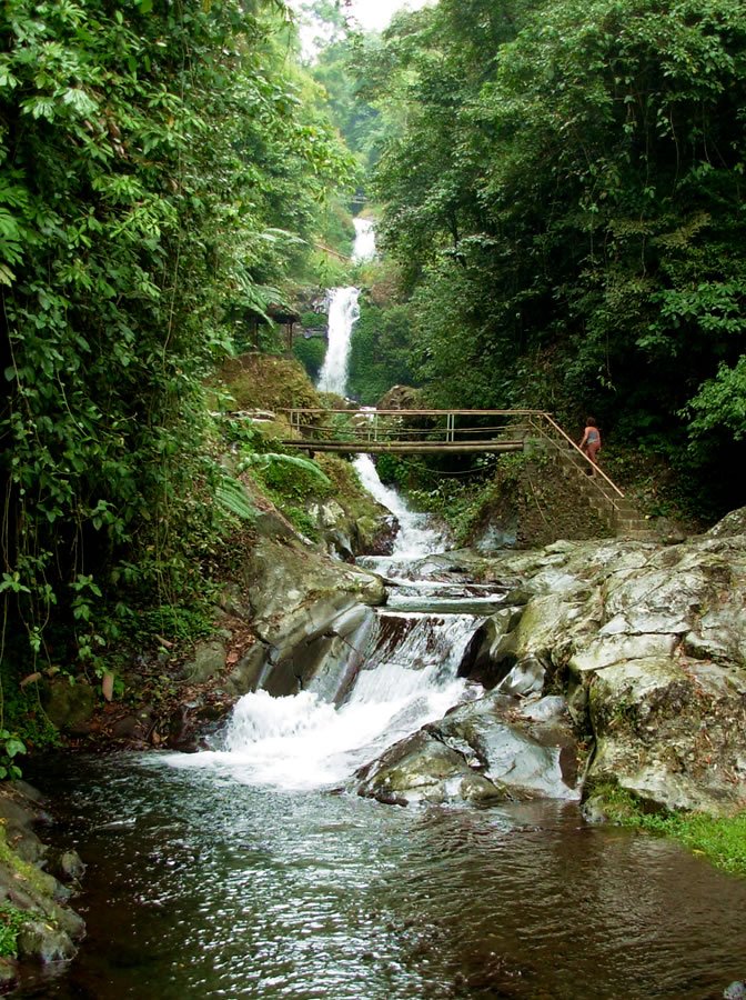 Multi-tiered waterfall in lush tropical rainforest