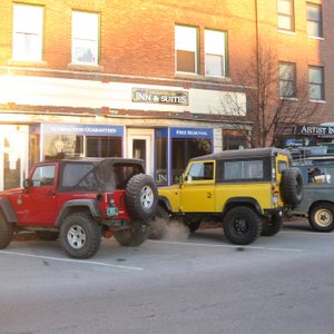 expedition vehicles parked in front of the inn
