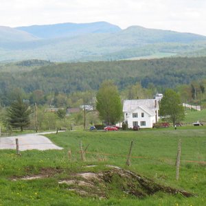 The B & B is in the distance as well as mountains.