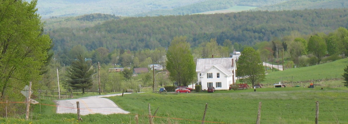 The B & B is in the distance as well as mountains.