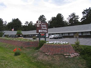 Saddle & Surrey Motel in Estes Park, image may contain: Hotel, Brick, Flag, Motel
