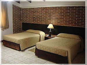 Dai Nonni Hotel in Guatemala City, image may contain: Furniture, Hotel, Brick, Fireplace