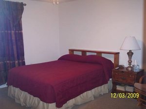 Sulphur Choice Suites in Sulphur, image may contain: Lamp, Bed, Furniture, Bedroom
