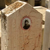Some old tomb stones carry a photo of the deceased