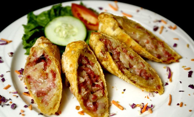 Our Signature Reuben Egg Rolls with homemade 1000 Island Dressing.