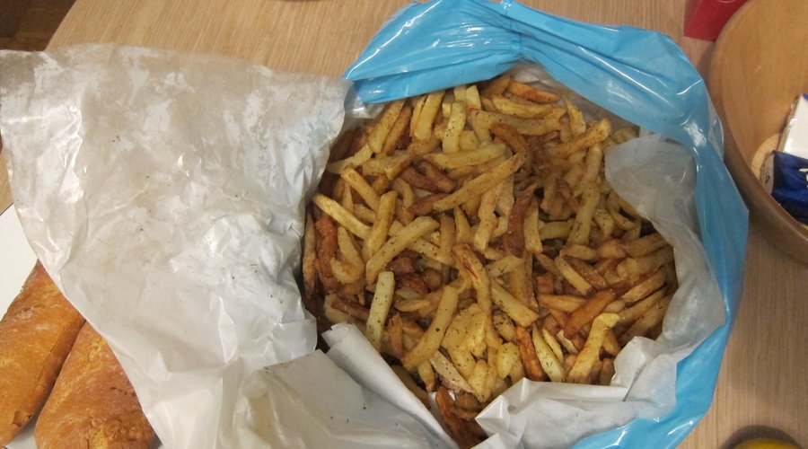 Fries on top with chops on the bottom.