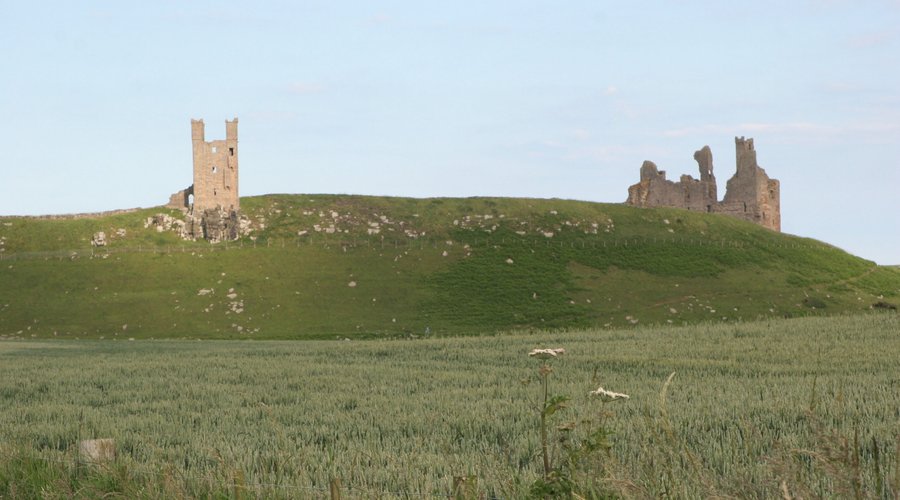 approaching Dunstanburgh Castle from the trail
