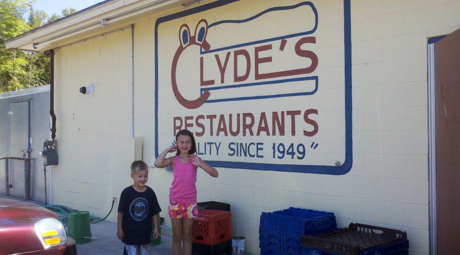 Two of my kids in front of the Clyde's sign.