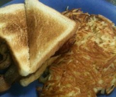 Bacon and Egg Toasted Sandwich with a side of hashbrowns..Yummy