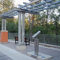 Rest area next to Elbow River on Elbow River Promenade