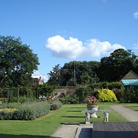 View from the back of garden looking towards front entrance with cafe on right