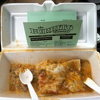 A delicious half-eaten breakfast burrito.