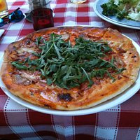 Burnt pizza with limp rocket