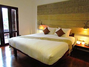 Victoria Xiengthong Palace in Luang Prabang, image may contain: Bed, Furniture, Bedroom, Indoors