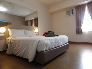 Red Planet Manila Mabini in Luzon, image may contain: Furniture, Handbag, Bed, Bedroom