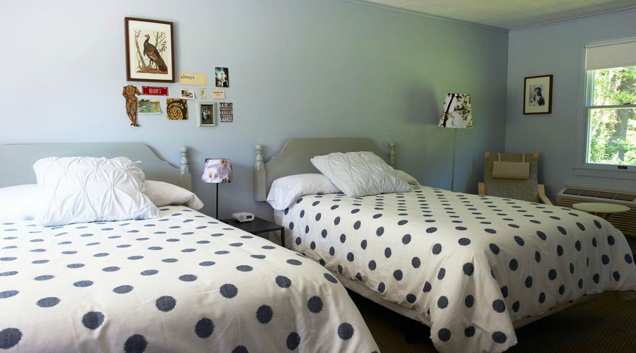 A room with two full-size beds