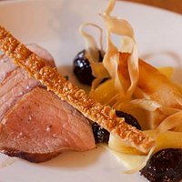 Roast loin of pork with parsnips, quince, prunes & roasting juices