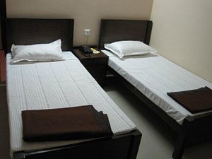Dwaraka Inn in Hyderabad, image may contain: Furniture, Bed, Hostel, Housing