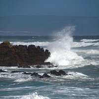 More crashing waves over the rocks out at sea.