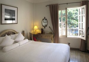 Ma Maison Boutique Hotel in Ho Chi Minh City, image may contain: Lamp, Bed, Furniture, Painting