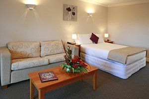 Kerikeri Park Lodge in Kerikeri, image may contain: Couch, Corner, Table, Coffee Table