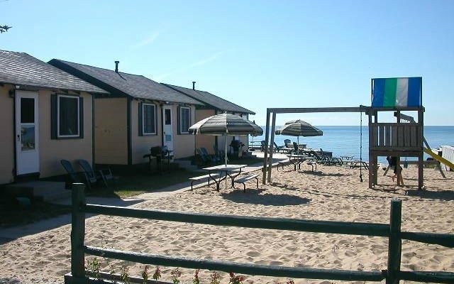 3 of the cabins and the sandy play area for kids!
