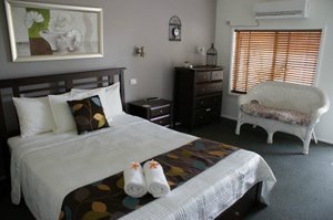 Riverside Motel in Karuah, image may contain: Bed, Furniture, Bedroom, Indoors
