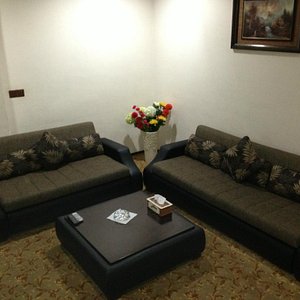 In-room lounge area with TV and comfortable chairs