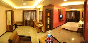 Madurai Residency in Madurai, image may contain: Lighting, Chair, Bed, Screen