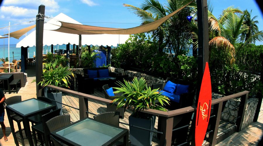 A beautiful sunny morning at rackams waterfront restaurant and bar area. grand Cayman islands