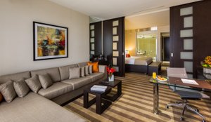 EB Hotel Miami Airport in Miami Springs, image may contain: Living Room, Couch, Home Decor, Table