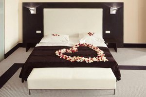 Old Town Square Residence by Emblem in Prague, image may contain: Furniture, Bed, Flower Arrangement, Plant