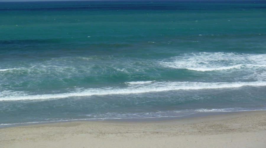 sitting on beach in front of apt