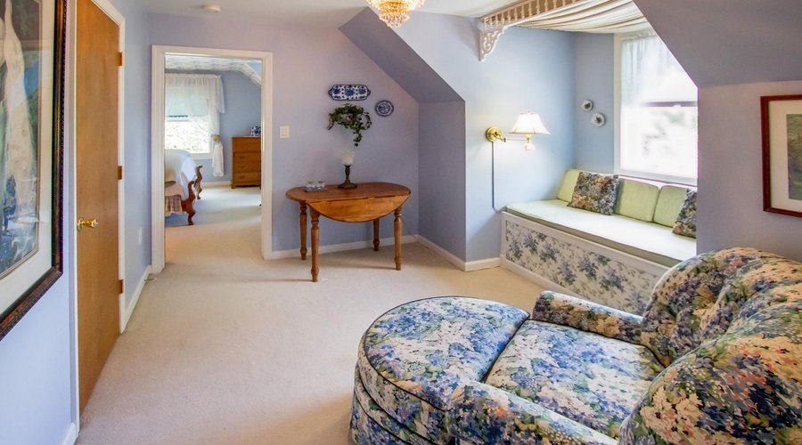The private sitting room in the Blue Ridge Suite features a window seat with long mountain views
