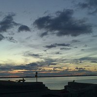 Clouds gathering as sun sets over Dublin - east of Seapoint beach