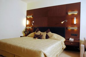 The Fern Residency, Subhash Bridge, Ahmedabad in Ahmedabad, image may contain: Interior Design, Furniture, Bed, Cushion