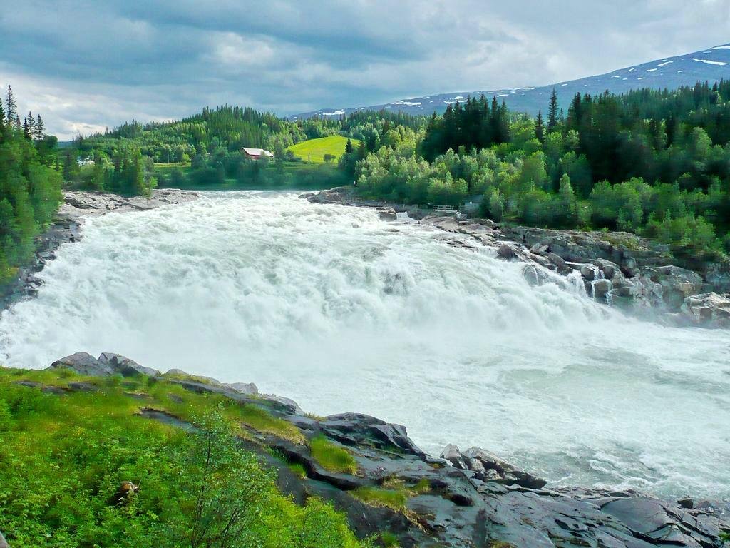 Laksforsen cascade in Grane municipality in Nordland Province in Norway  running over some 17 meter high cascades over a rocky stretch Stock Photo -  Alamy