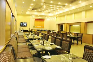 Hotel Park Grand in Haridwar, image may contain: Restaurant, Indoors, Dining Table, Dining Room