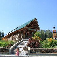 The gardens and waterfall next to the bridge