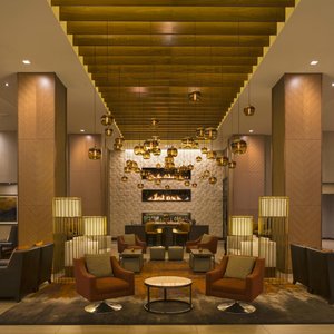 Arriving guests are greeted with linear stacked fireplaces on a 29 ft wall. 