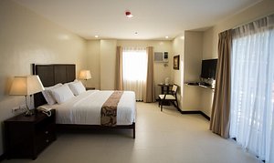 Main Hotel & Suites in Cebu Island, image may contain: Corner, Bed, Furniture, Bedroom