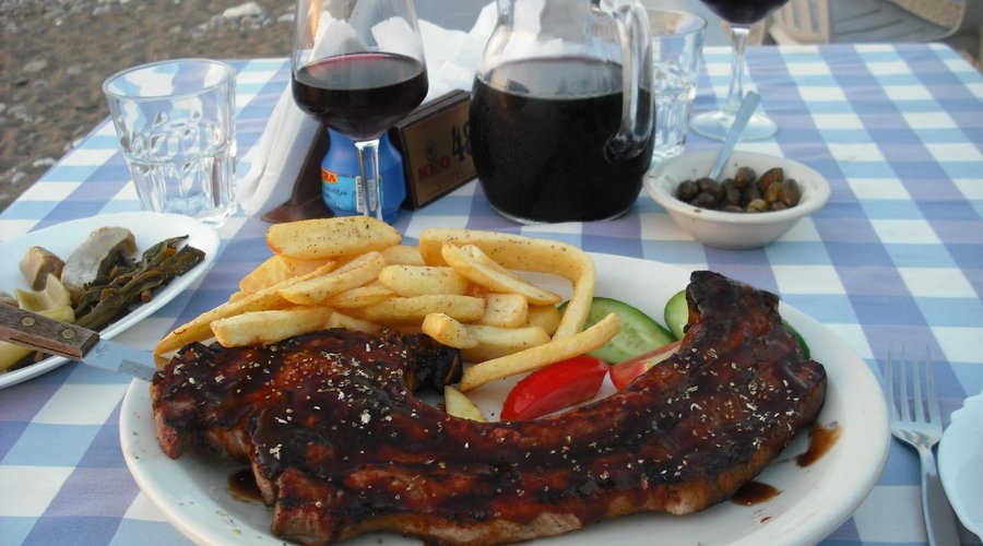 Pickled veg, olives,wine and Barbequed pork chop at Yialos.