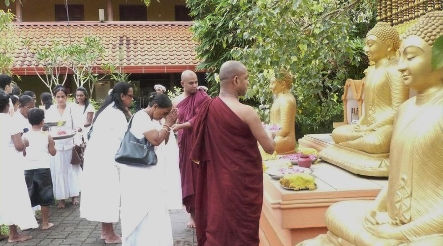 Devotees passing offerings