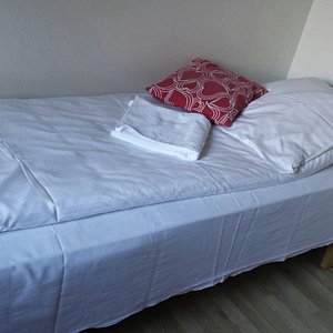 One of the beds in a 2 person room.