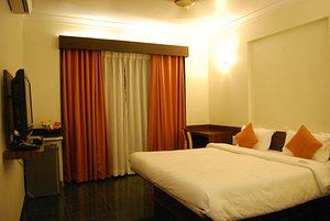 Hotel KB's Grand Shirdi in Shirdi, image may contain: Bed, Furniture, Monitor, Bedroom