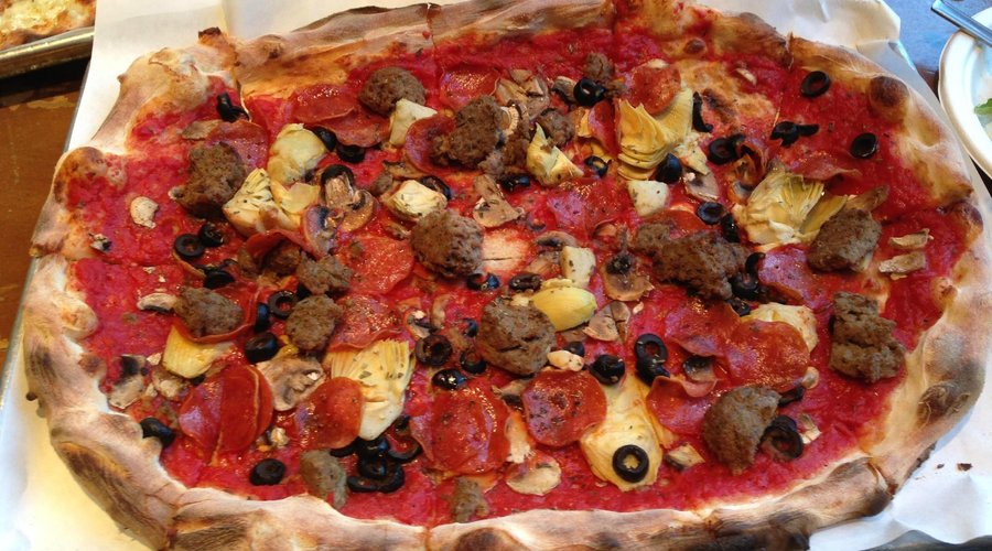 Red sauce pizza with mozzarella, meatball, mushroom, black olives, artichoke hearts and pepperon
