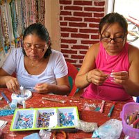 Women beading in the coop